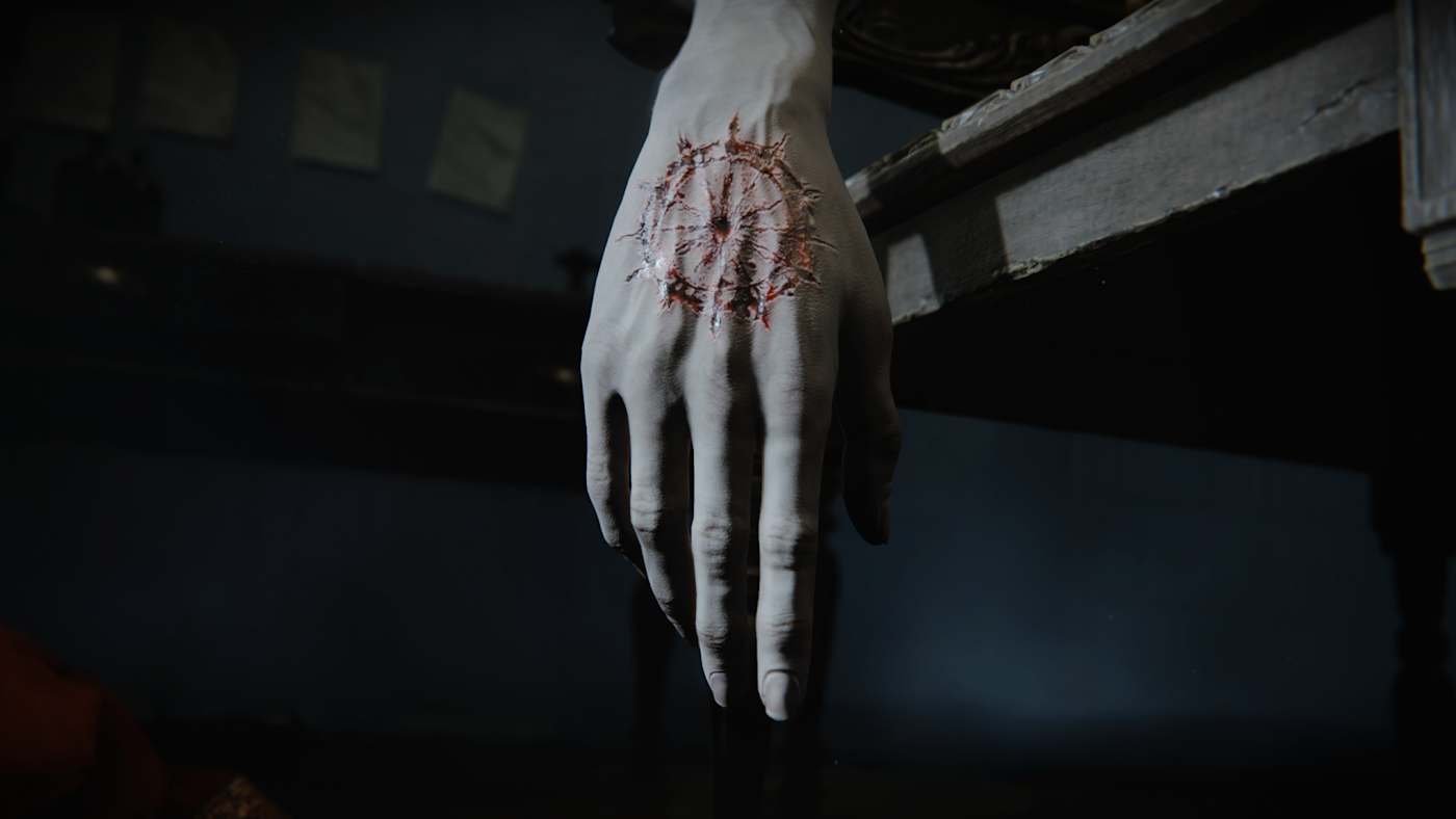 A pale hand marked with a circular blood sign.